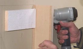 Nail the sides of the mantel legs to the backing.