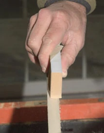 Use a section of the scrap cut off from the arc as a sanding block to match the curve of the arc.