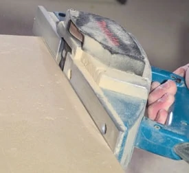 Use a power planer to shape along the scribe marks.