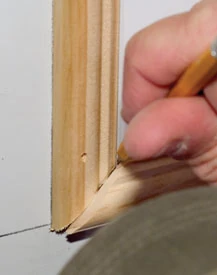 The miters at the arced horizontal piece will need a little extra attention. You can overlap the horizontal piece over the vertical and trace the angle. The new angle can be cut with a sharp utility knife.