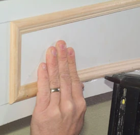Apply carpenter's glue to the back of the bottom horizontal piece and bend it into place following the layout lines. When you like it, nail it.