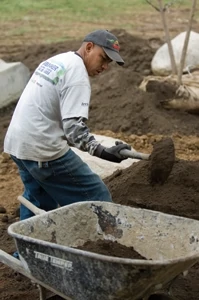 After positioning the rocks, Ashland's guys spread loam to prepare the landscape for a variety of plants.