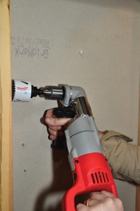 The water supply and electrical lines were routed through the wall studs. A right-angle drill is a handy tool for drilling the studs.