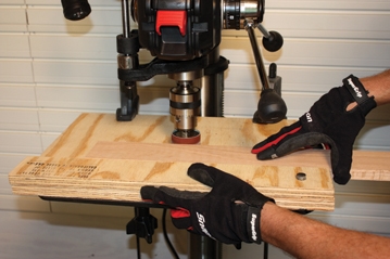 Run the workpiece between the sanding drum and the fence to sand the full edge of a board.