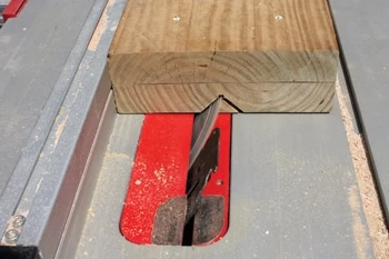 To make the pipe jig, I fastened together two 2x8s and cut a 90 degree V-notch down the center with a table saw.