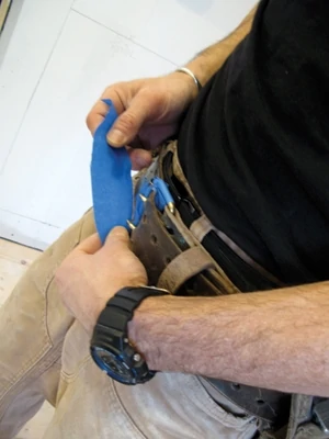One of my biggest fears installing cabinets is hitting them against my belt buckle and damaging a door. It's never happened to me, but I don't want there to be a first time. As a layer of protection I wrap the buckle in blue tape before going to work.