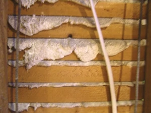 Shown is the back side of a plaster ceiling from above. You can see the plaster is still squeezed through the lath, suggesting that it is still firmly attached to the structure. However, if these squeeze-through blobs are broken below is looking for an excuse to come loose.