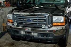 Shown is the front of our Super duty before installing the new winch. We found that the fog light locations were OK, but the driving lights would have to move.