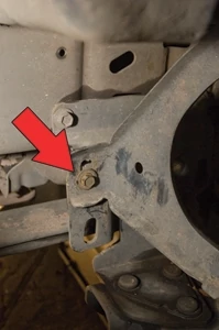 Find these angle brackets inside the fender wells. A bolt on each side needs to be removed to detach the bumper.