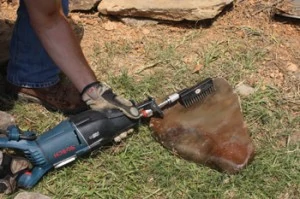 I had to clean some of the creek-bed stones to reveal the original rock face. Shown here I've attached a stiff-bristled brush from Recipro Tools onto a reciprocating saw for some easy automated scrubbing.