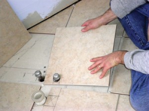 SANYO DIGITAL CAMERA7 For the bathtub drain, I simply inscribe an outline of the drain hole on the tile and then use a wet saw with a diamond blade to cut from the outer edge of the tile up to that line. I then snap those pieces off with my tile snips.