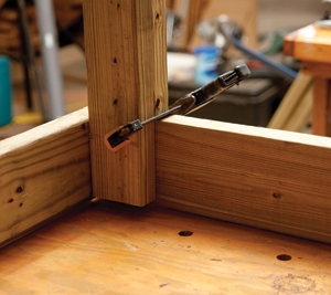Use one clamp to hold the legs when drilling the carriage-bolt holes.