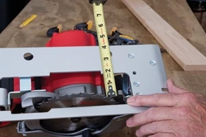 If cutting plywood with a guide board, measure the saw to the inside of carbide tooth.