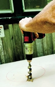 If adding a lift-out basin, first mark your circle cut and then drill a starter hole for the jigsaw.