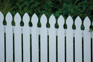 A lower top rail and larger gaps would have helped the look of this fence. In general, a picket fence should have gaps between pickets that equal the width of the pickets.