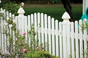 This vinyl fence creates interesting lines with the post caps and varying length of pickets.