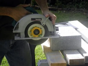 A wet saw does the best job of cutting concrete and block, but occasional cuts can be made with a handheld circ saw equipped with a carbide blade.