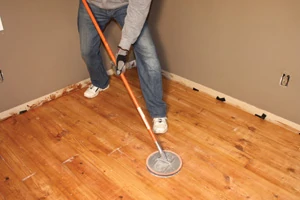 After the poly dries, scuff-sand the floor between coats to promote better adhesion of the next coat of varnish.