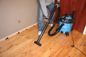 Dust is the enemy of a nice finish. Vacuum all dust and debris from the floor prior to recoating.