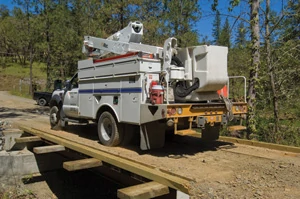 Soon after completing the bridge, Jon Ford started a house construction project so construction traffic like this power company truck put the new bridge to good use.