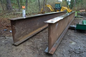 Jon Ford purchased a pair of steel I-beams rated to carry the load of the bridge from a local steel company.