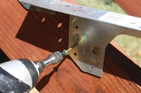 I used four 1-1/2” No. 8 cone-head exterior screws in the predrilled holes of each bracket.