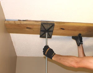 A T-Jak is a helpful tool to support the top plate while you install the studs.