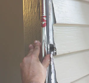 Wrap the door frame with weatherproof flashing. I used a self-adhesive flashing arrier fro Cofair Products.