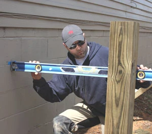 Determine the anticipated height of your deck, then measure downward, subtracting the thickness of the decking and the height of the joists and beam. Transfer this measurement to the posts to determine where to cut them to accept the beam.