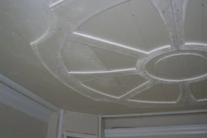 The wagon wheel detail is then screwed to the ceiling.