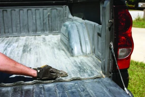 Scuff-sand every square inch of the truck bed prior to applying the liquid liner. After sanding, either pressure-wash or wipe down the bed with a rag and alcohol to remove the dust.