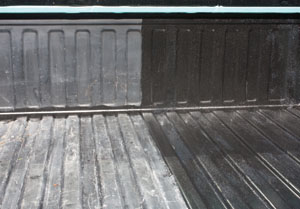 This photo shows the stark contrast between the first coat of liquid liner and the prepped surface of the truck bed.