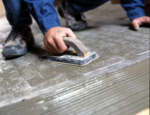 Use a rubber float to press the entire mat surface to firmly create 100-percent contact between the heating mat, the mortar and the subfloor.