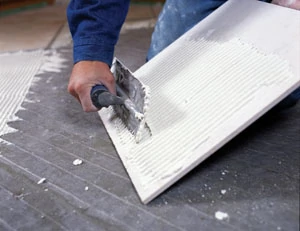 It may help to butter the backs of the tiles with thin-set for better adhesion to the mortar bed.