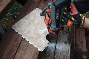 For straight cuts in tile, I used a wet saw. However, for irregular or oddly shaped cuts, I used a Rotozip equipped with a special tile-cutting bit.