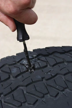 Insert the plug, making sure the plug material remains on both the inside and outside of the tire to seal the damage from both sides. Remove the insertion tool and test the plug with soapy water. If it still leaks, repeat the procedure with another plug.