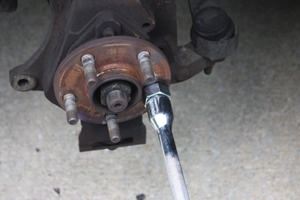 Tighten the lug nut with a wrench