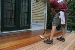 Before completing the rail system, exterior wood stain was applied while the crew had unobstructed access to the decking