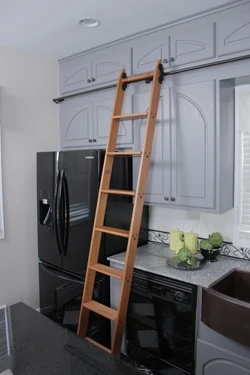 Ladders come in all shapes and sizes, such as this wooden kitchen ladder from Putnam Rolling Ladders, which allows convenient access to overhead storage cabinets.