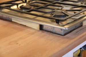 We used small spacer wood blocks to lift the cook-top off the counter. 