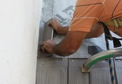 At the wall abutments, step flashing is installed under each transitional tile. 