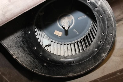 Signs of age: this unit’s blower motor has chunks of plaster inside it. The blower is often the first piece to go when a system starts to fail. It is replaceable, but replacing it generally means the rest of the unit is on borrowed time. 