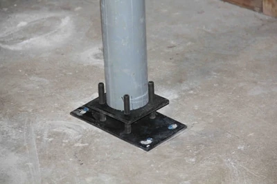 Once the adjustment screws are tightened, the adjustment plate lifts the column into place for final installation. The gap between the adjustment plate and bearing plate can then be filled with concrete of grout. 