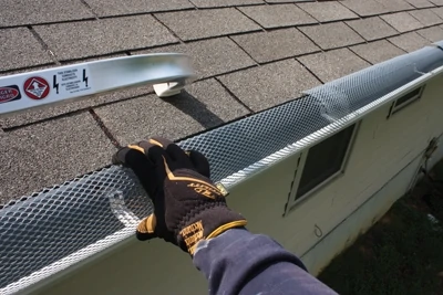 Check the roof for worn or missing shingles and flashing. Use binoculars to inspect all roof penetrations, including the chimney. Make sure the gutter is free of leaks and clogs. Gutter covers help to keep leaves and debris from accumulating and impeding drainage.