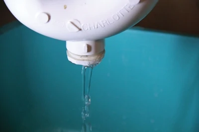 The drain plug can empty water from the trap, but dropped items are usually too large to fall out of the cleanout hole.