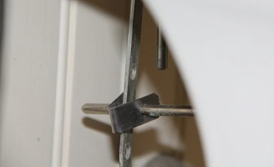 The pivot arm of the drain plug is attached to the faucet’s control lever by a retainer clip.