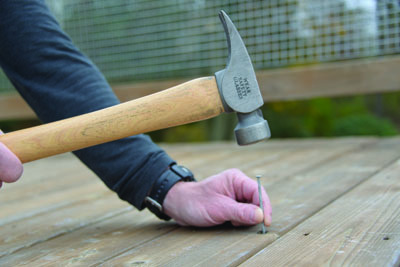 Replace loose fasteners with quality decking screws or spiral/rink-shank nails. Also, inspect the framing connections beneath the deck.