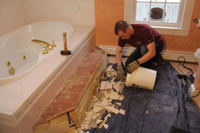 Bathroom demolition creates a substantial amount of garbage in the form broken drywall and shards of tile. Plan a way to dispose of the material in an orderly fashion.