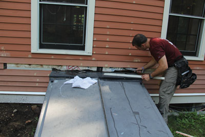 Siding had to be removed to disassemble the old door.