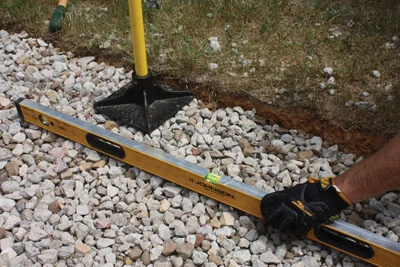 Tamp down and level the gravel bed. 